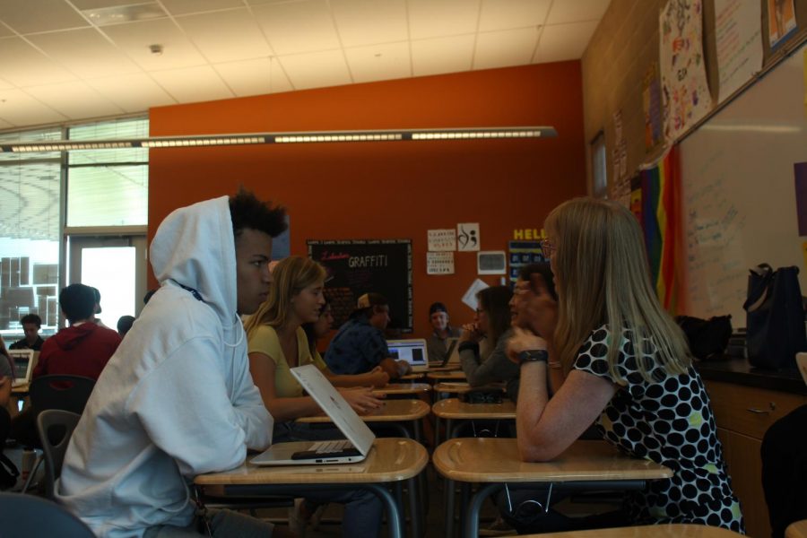 Professional Joanne Hackett gives advice to senior Tyler Hill. The professionals are there to help students with problem-solving throughout their Genius Project.