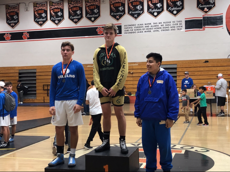 Freshman Luke McLellan stands on the first place podium last Friday. The freshman wrestling team had a tournament at Escondido High School were McLellan took first in the 172 weight class.