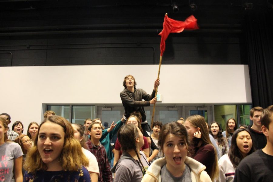  The cast of Les Miserables sing their hearts out in rehearsal, waving a flag of revolution above their heads. The students worked hard over the last month, and continue to practice their show until February.