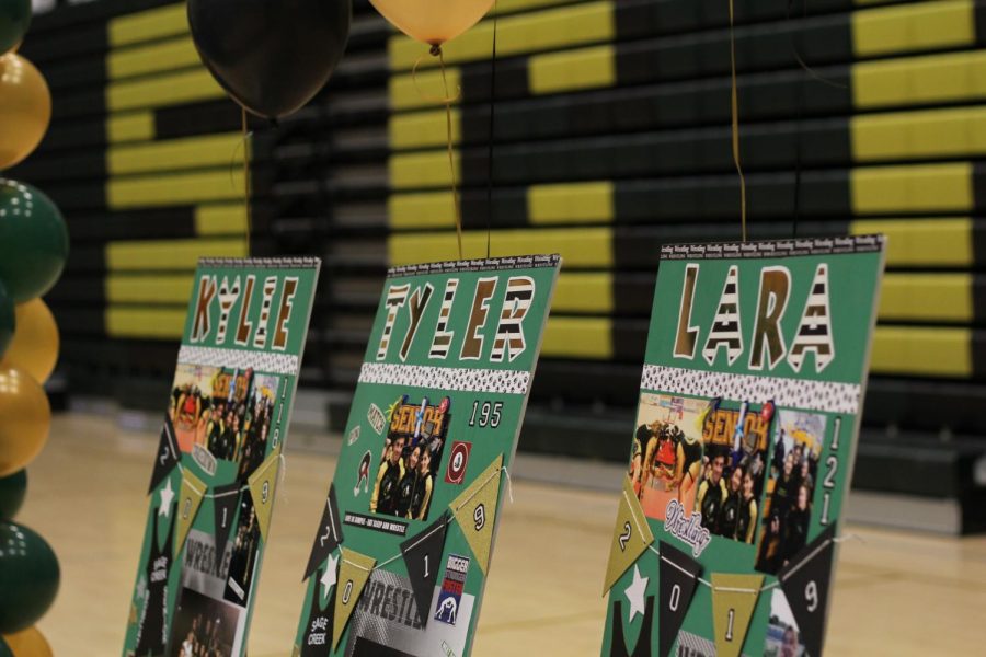 Boards are shown on a table with memories of the senior wrestlers from their time on the team. Last weeks dual was the last time that the seniors on the wrestling team would match up on that mat.