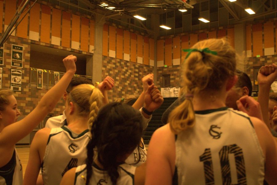 The girls basketball team cheers before heading onto the court for the final quarter. The team won against Oceanside 42- 24. 