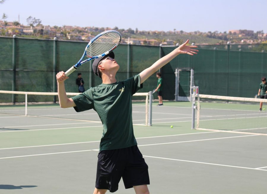 Andy Goh prepares to serve to his opponents. As a strong server, Goh helps his teammates prepare for tough competition.