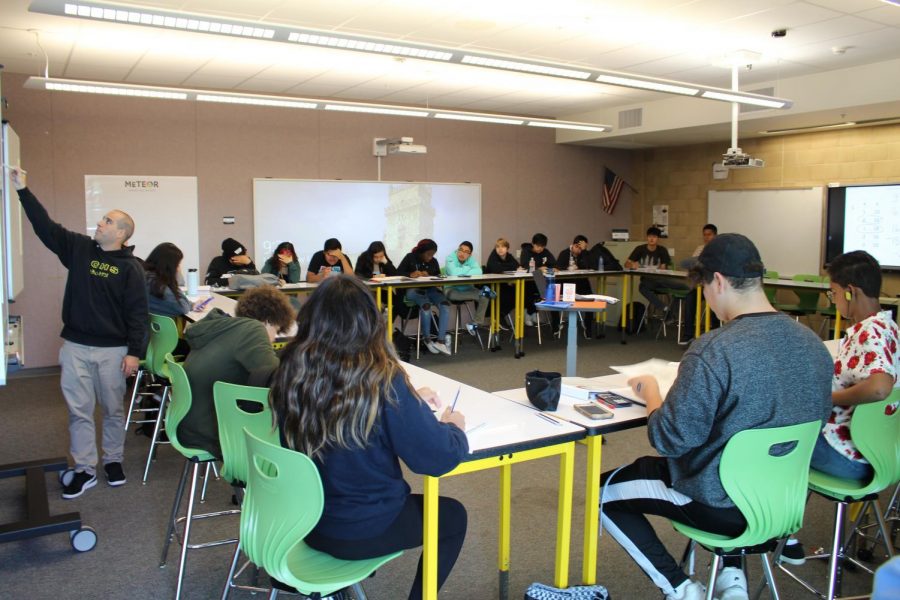 Students in Mr. Manente’s second period are seated around the classroom working on their assigned classwork. Due to the rooms recent remodeling, students now have access to multiple monitors, and tables that act as whiteboards to help them learn.