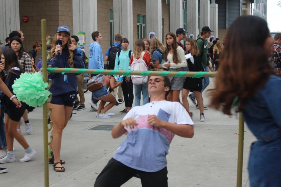 Senior Mikey Moran participates in Thursday's lunch limbo. As a part of Hello Week, ASB planned fun lunch activities, including this limbo competition for class cup points.
