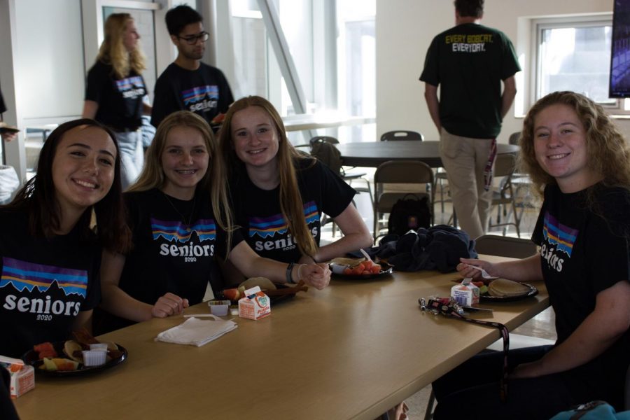 Seniors enjoy the pancake breakfast in the cafeteria after the senior panoramic photo. Last Wednesday, seniors chose their pick at the buffet line from items such as bacon and pancakes. 