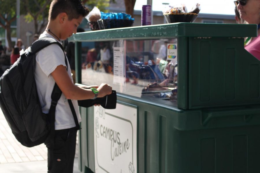 A student buys a snack during lunch. Campus Cuisine, open every day during lunch, provides a quick bite to eat such as brownies, chips, cookies and much more. 