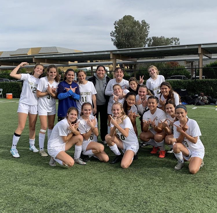 The Girls JV team poses after winning a game. The score was 2-1. 