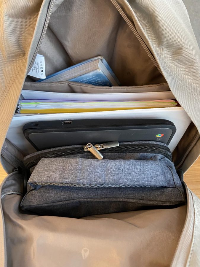 Freshman Jonah Hacker stores Chromebook in his backpack. Chromebooks can now be taken anywhere and so students carry their Chromebooks in their bags, allowing them easier access.