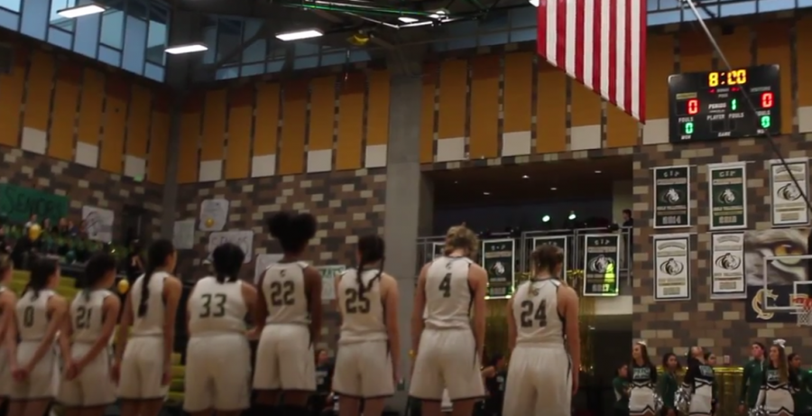 Girls varsity basketball stands for the National Anthem at their Hoopcoming game against Oceanside. The lady bobcats triumphed over their rivals with a score of 50-47.