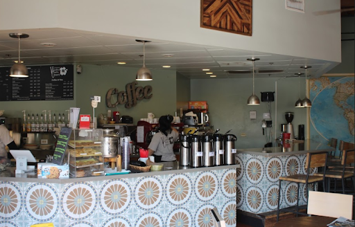 The cafe has a big “coffee” sign over some of the condiments offered for any of the drinks. And more color on the tiles to the counter that wraps around the cafe.