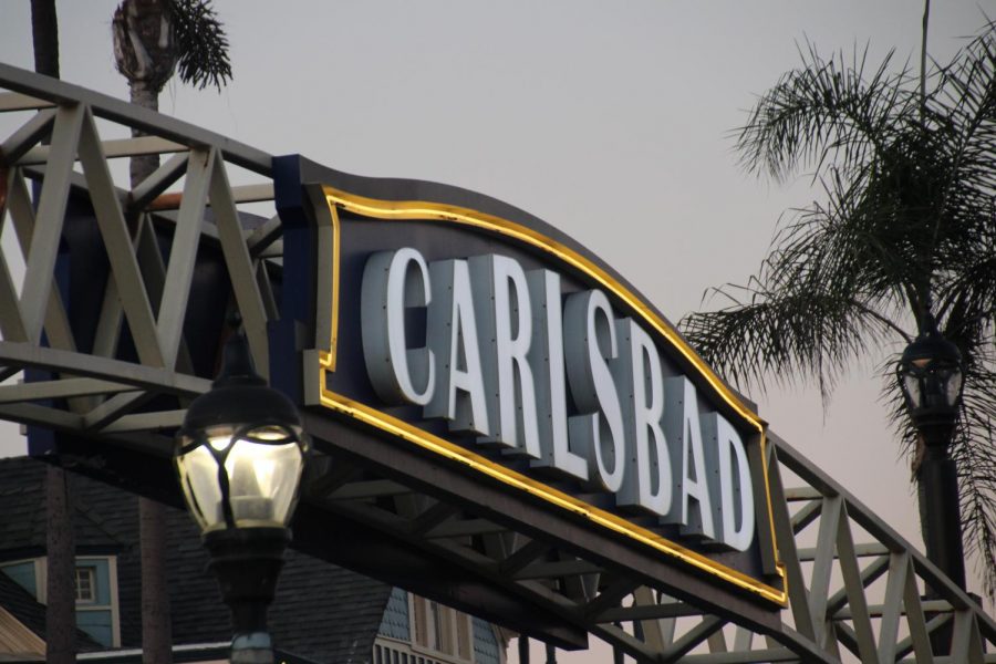 The iconic Carlsbad sign illuminates the sky as night falls. As the sun began to set, the Carlsbad sign lit up the streets in the village.