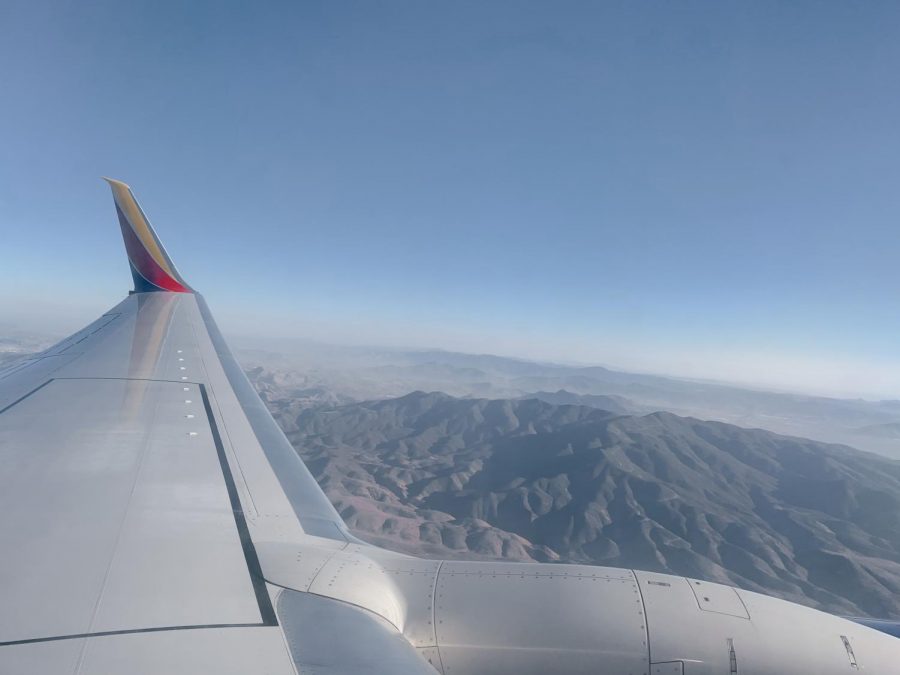 A plane from Southwest Airlines flies into the San Diego International Airport. To prevent the spread of COVID-19, travellers are required to wear facial coverings for the entire duration of their flight, and middle seats are no longer available in order to practice social distancing in the air. 