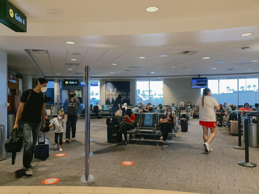 A group of people exit a plane at the San Diego International Airport. As of July 1, SAN has measures in place like increased signage, cleaning of high-traffic areas and seat separation near the boarding gates to slow the spread of COVID-19. 