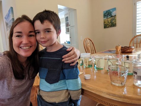  AP Biology teacher Allison Magee does a lab with her son while her students begin theirs at home. Students in AP Bio had been studying osmosis and were given a 3-day lab to see how eggs react in different solutions.