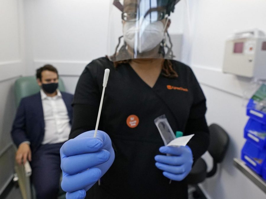 A medical assistant holds a swab after testing a man on at new COVID-19 testing facilities in Boston. With 88,500 new coronavirus cases, new testing facilities are being put around the country.According to CNBC, “The U.S. reported more than 88,500 new coronavirus cases on Thursday, [October 29] a record daily high since the beginning of the pandemic”.