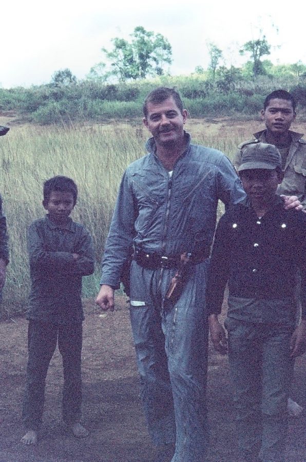 Jerry Jones stands next to some citizens for Laos. Jones was able to meet many different people, especially during his time overseas.