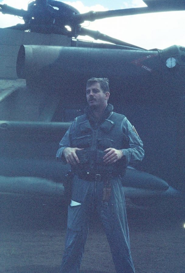 Jones stands in front of his helicopter. Jones served in the military for 20 years. 