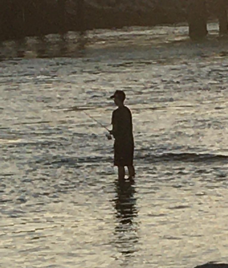 During COVID-19, due to social distancing rules solo water activities are very popular such as fishing. This teenager at the rivermouth that leads to the Batiquitos Lagoon from Ponto Beach is seen fishing for fun.