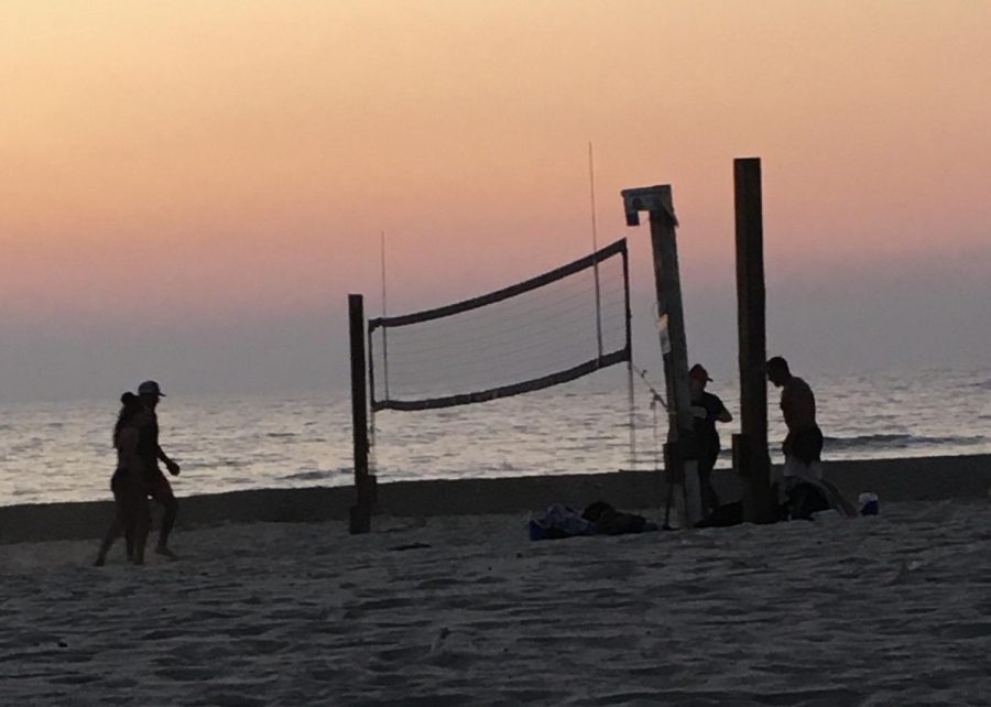 At North Ponto Beach, after a long beach day a group of young adults sets up a volleyball net to play at the end of the day.  With the COVID-19 pandemic still a major influence in our day to day lives, many people have decided to go to the beach because it’s an outside activity where people can maintain proper social distance. 