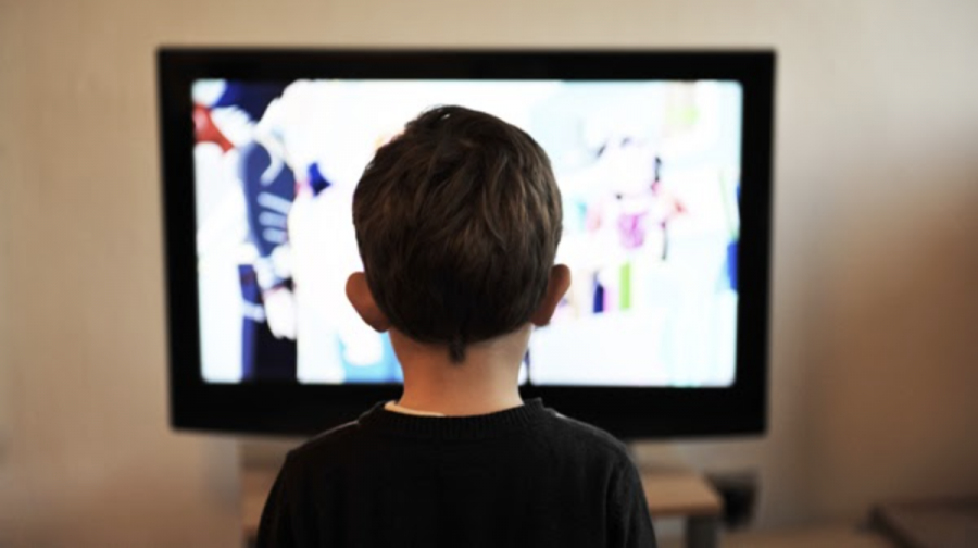 A young boy enjoys a DVD film. Before streaming services were created, many children used DVDS so they could watch their favorite films.