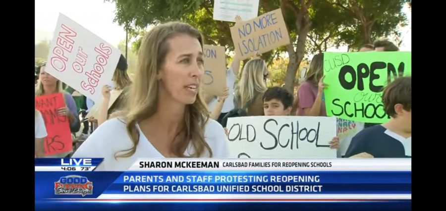 Parents and community members stand in protest against Carlsbad Unified School Board's decision on reopening schools.  They claimed that schools being closed has caused an increase in mental health issues and that students aren’t getting proper education online. 