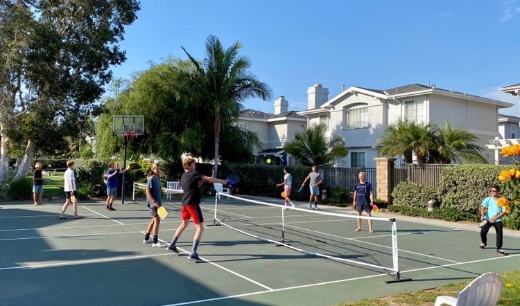 Wyatt and his friends are playing pickleball at a local court. He likes playing pickleball because everyone is pleasant to play with, and he often makes new friends. 