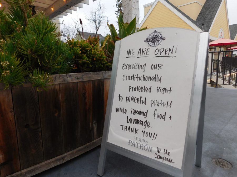 A restaurant in the Carlsbad Village displays a sign noting their “constitutionally protected right to peacefully protest while serving food and beverage.” Many restaurants in the Village have stayed open amidst state shutdown orders in an effort to save their business and the jobs of their employees. 