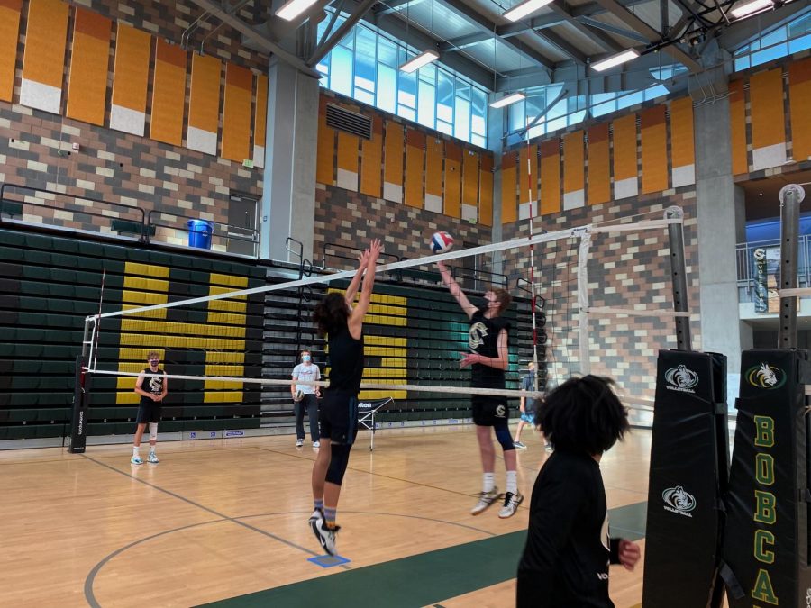 Sophomore Aaron Speirs goes up for a block.  With limited gym space Varsity, JV and Frosh teams have to practice all together. 