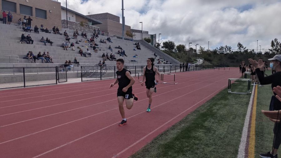 Senior and Varsity athlete Noe Avila (on the right) running the mile. Although unofficial, this was still the first meet since spring of 2020. 