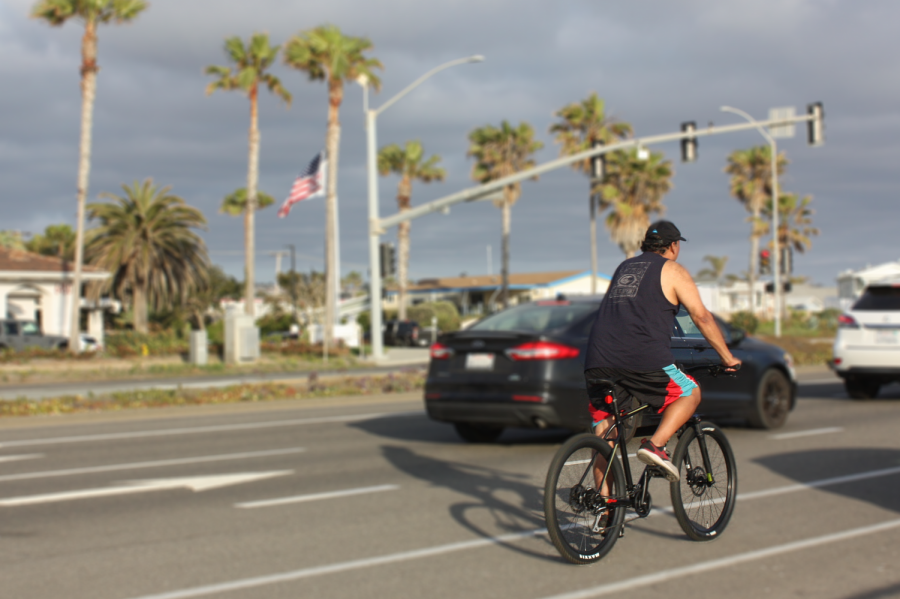 A man stops at the light while cruising along the Carlsbad coast. Bicycling, as a whole, has seen a major increase in popularity that some call the “bike boom”.  