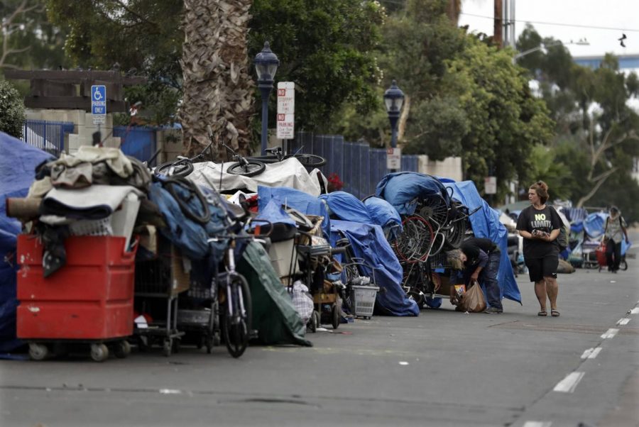 A homeless community sets up camp on the side of a busy San Diego road. Downtown areas are often overrun with full shopping carts and tents as many of these people have nowhere else to go. 