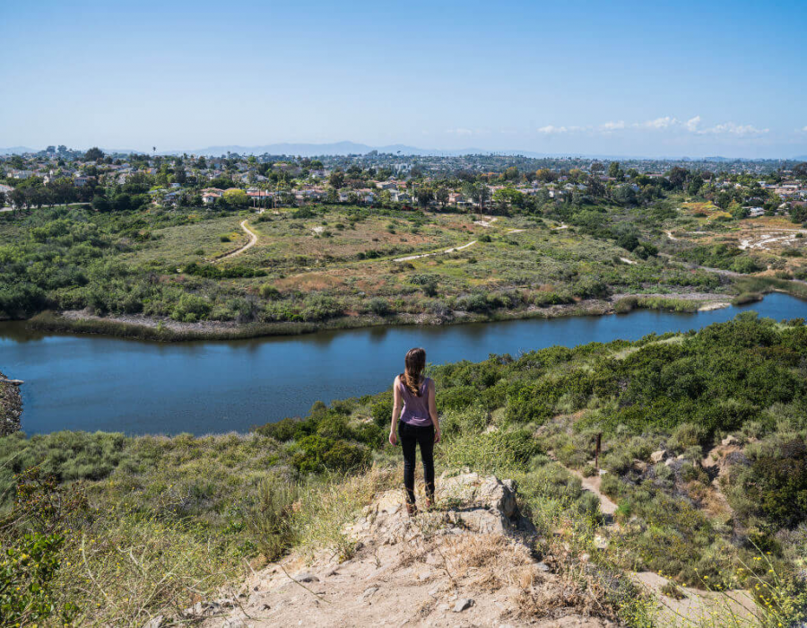 A woman hikes the 3.4 mile hike up Calavera Mountain. Calavera Mountain provides a serene, dog and bike friendly trail. 