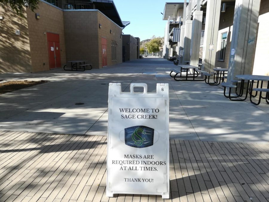 After the school day, most students have left campus but the signs telling people masks are required indoors remain. Masks are required indoors but optional outdoors.