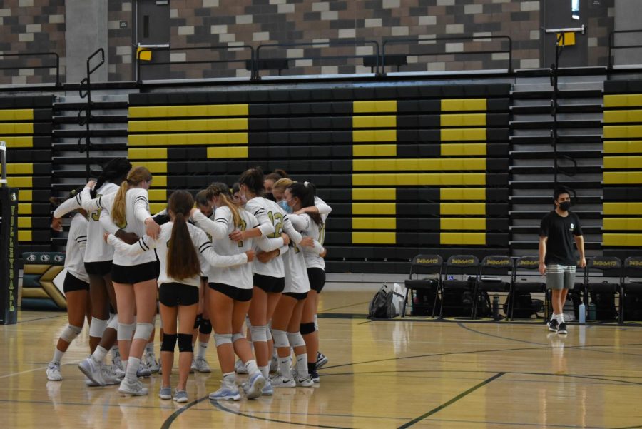 Members of the volleyball team hug before their game against Torrey Pines. The team was defeated three sets to zero. 