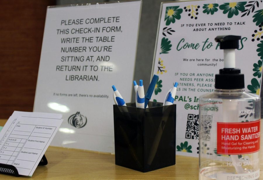  A sign-in station awaits visitors at the entrance of the library with hand sanitizer at hand. The library developed a system that would aid the process of contact tracing. 