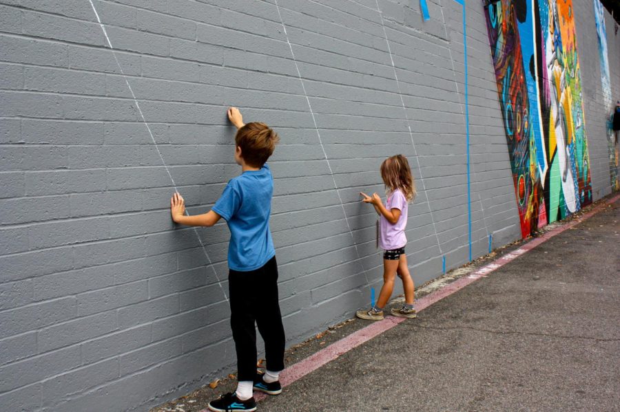 Henry and Stella Snyder plan out what they will be painting when the mural is open to the public. The project aims to inspire people of all ages to join in the Carlsbad art scene.