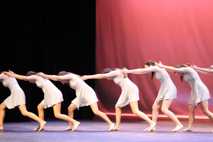 Dance Company forms a flowing chain during Ashley Kao’s special piece. The white dresses symbolized innocence, contrasting the vibrant red, which signaled external dangers. 