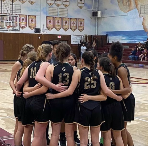 The team huddles before their game. Their teamwork helps them communicate and succeed to the best of their ability.