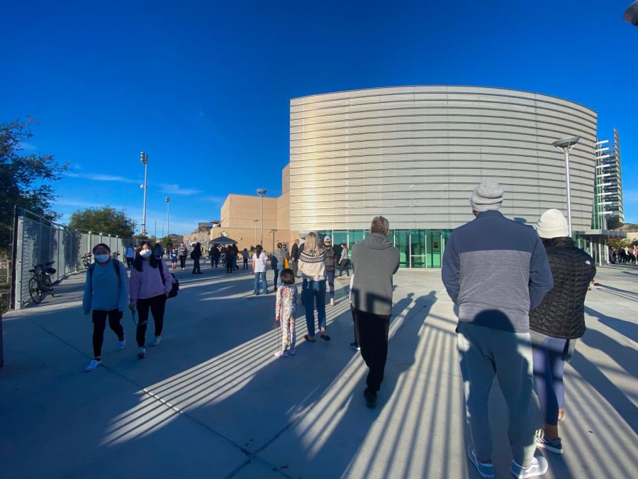 A line of people forms outside the gates of Sage Creek at the on-site coronavirus testing booth during school dismissal. An increase in testing has been evident after the winter break. 