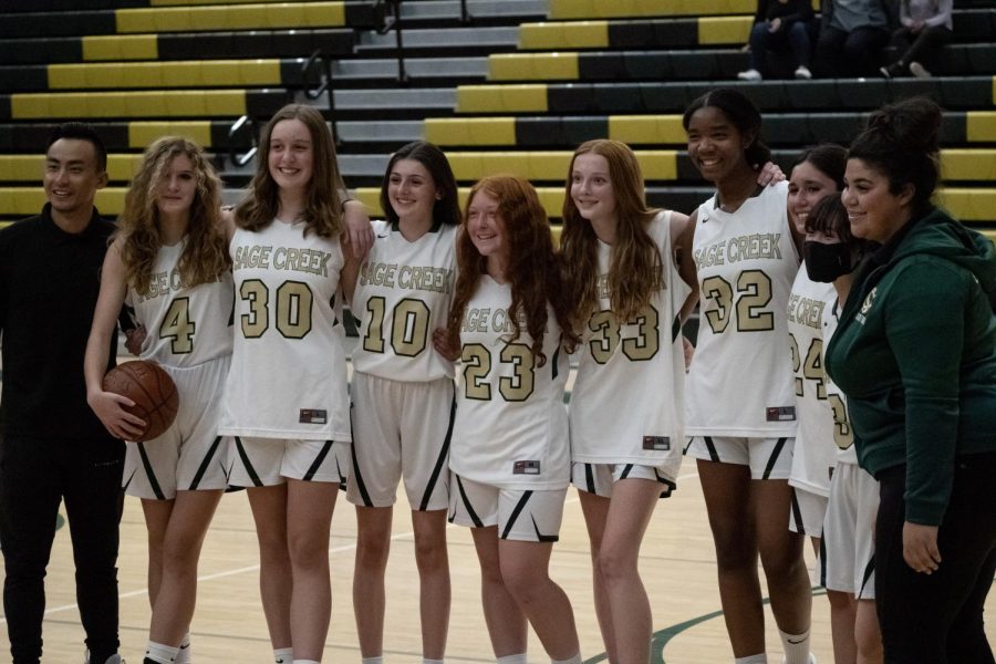 The team poses for a photo at the end of the game after a win. The team had a 533 point differential this season.