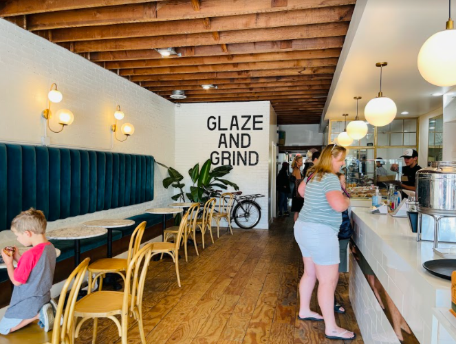 A customer pays for their delicious doughnuts from The Goods. Inside, The Goods has a beautifully set up decor, welcoming their customers to stay while they eat. 
