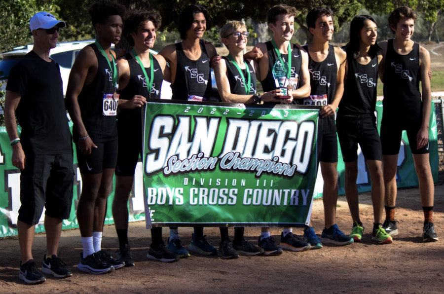 The boys cross country team with their section champions award. The  team posed with their Divison 3 section champions banner.