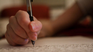 A High school student writing a college application essay during college application season. Photo taken and created by Rubin Adbi.