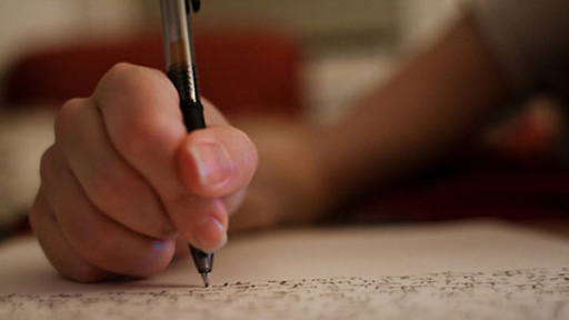 A High school student writing a college application essay during college application season. Photo taken and created by Rubin Adbi.