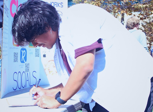 Abe Ibañez, a junior at Sage Creek, signs up for the Crumbl Club. He joined 5 other clubs and is looking forward to participating in them.