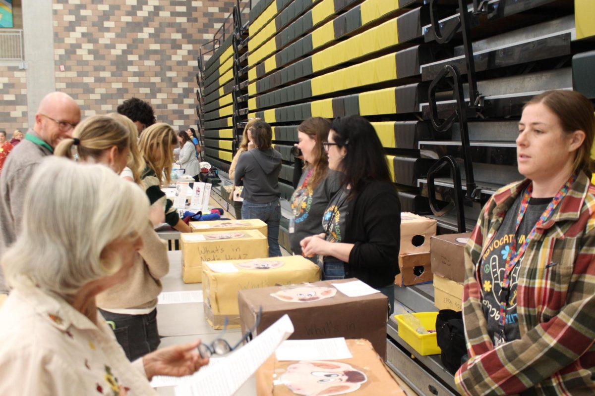 Attendees of Community Compassion Day stop by various booths run by various educational departments. These stations demonstrate the struggles those with disabilities go through daily.