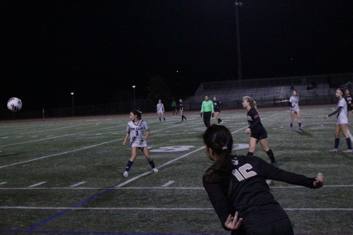 Number 16 Alexie Farinella does a throw-in from the sideline to a teammate downfield. A throw-in happens when a player kicks the ball out of bounds, and the opposing team gets to throw the ball back to their players.