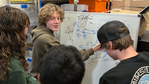 Trennan Lange leads a design brainstorming session. All robot components start in the brainstorming phase before being CADded (Computer-Aided Design) and later created.