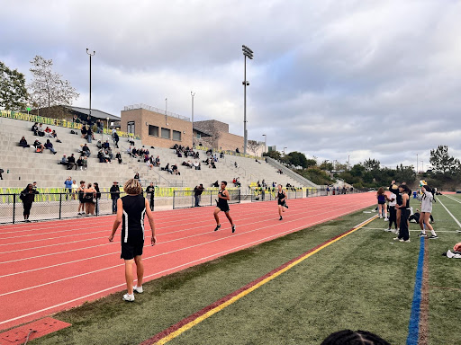 The crowd cheers as Miles Gray runs the 1600. He got a time of 5:27.58.