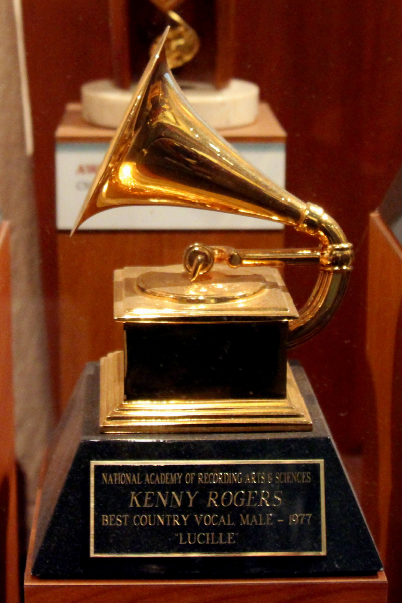 A Grammy Award trophy is shown on display, with a simple gold design. The shimmering  gramophone is plated in 24 karat gold. 